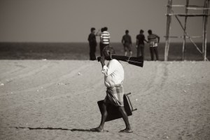 Old man and young boys on Marina beach, Chennai