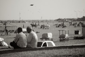 Men chatting by the Marina Beach in Chennai