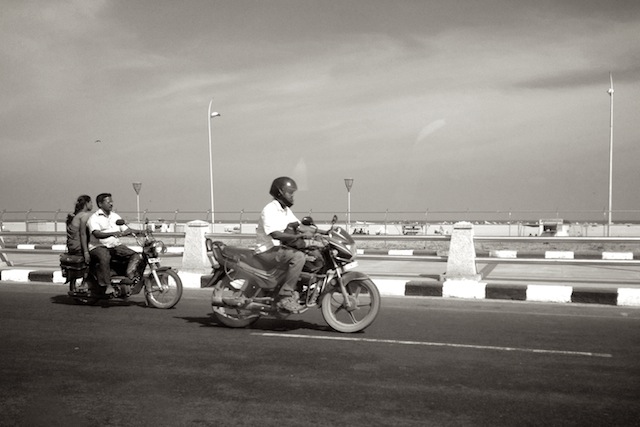 People driving on the road next to Marina Beach, Chennai