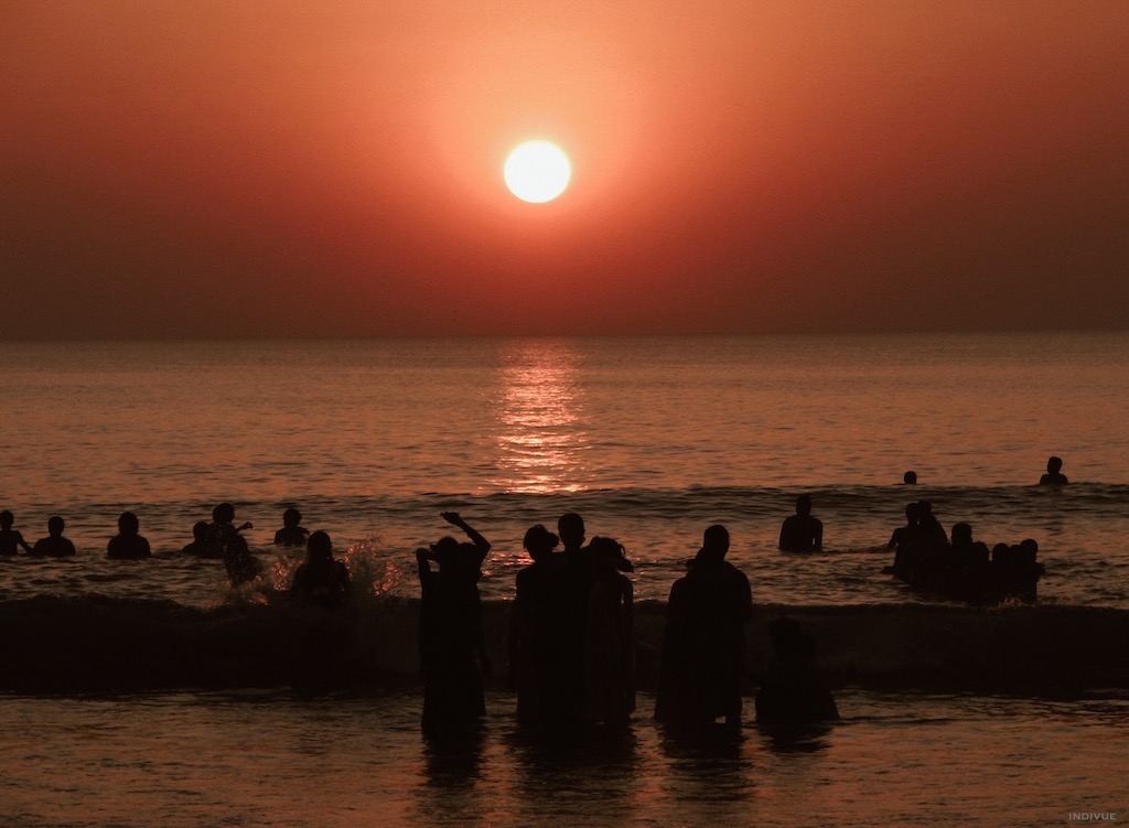 People swimming during sunset in Gokarn Beach