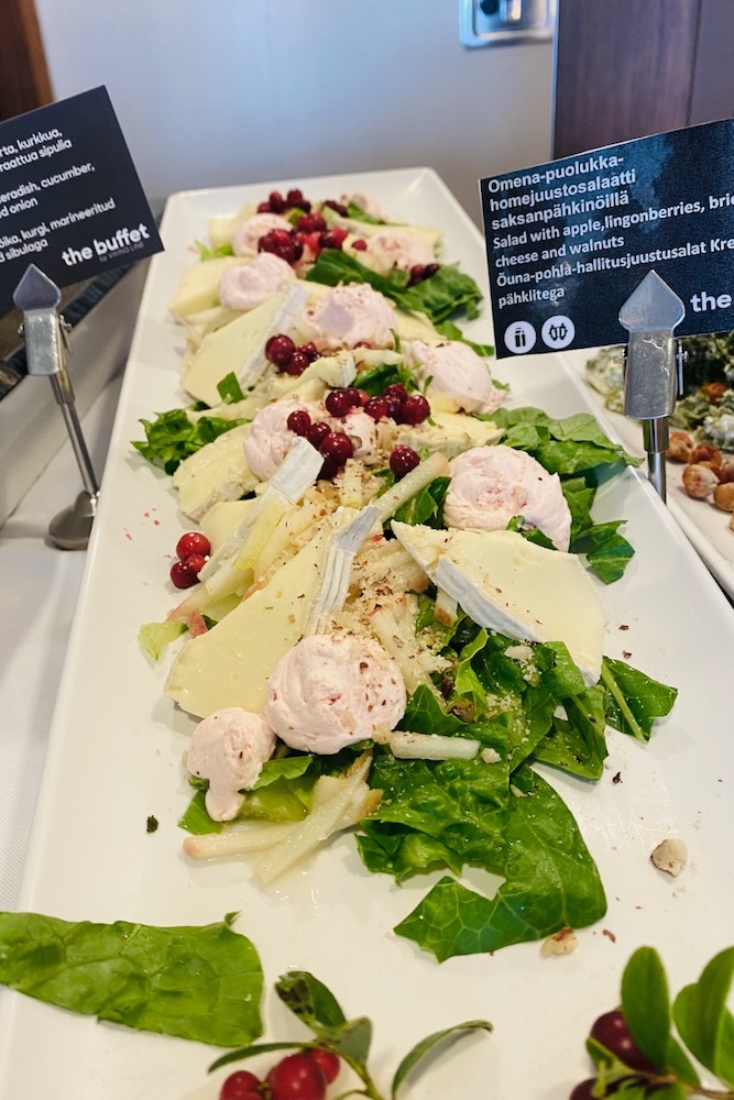 Salad with apple, lingonberries, brie cheese and walnuts in Viking XPRS buffet lunch