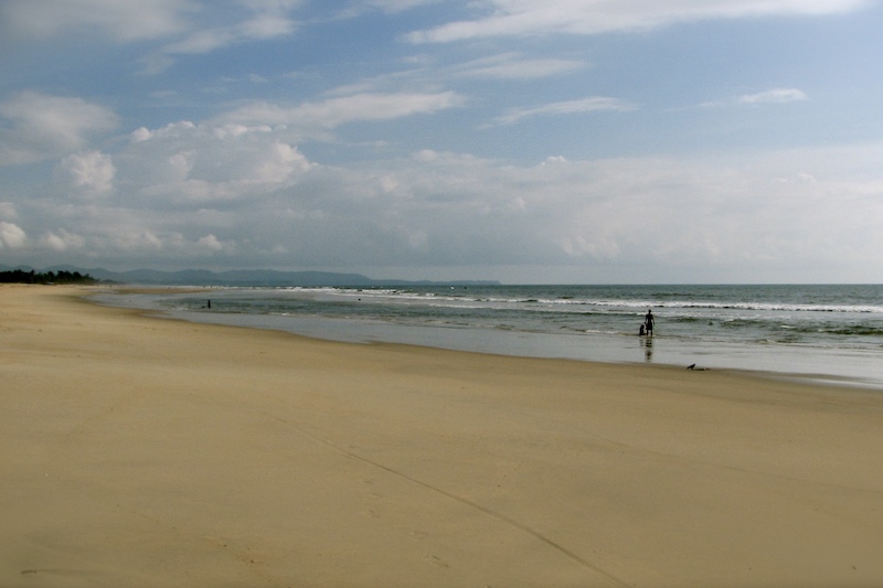 Two people on a sunny South Goan beach in India