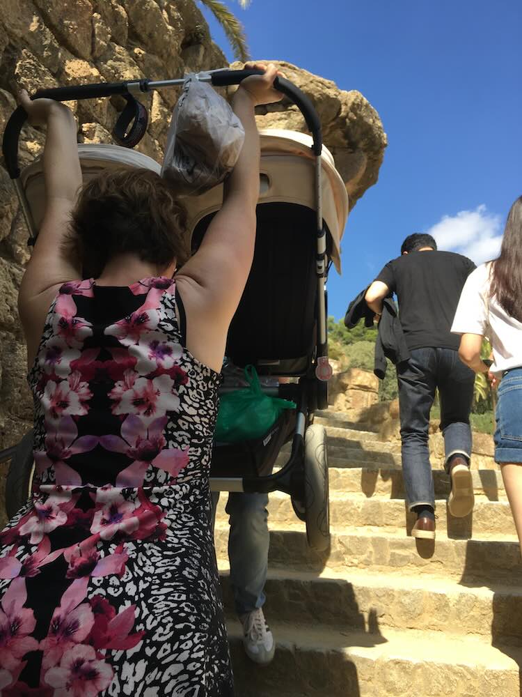 Tourist parents with push chair in Park Güell, Barcelona