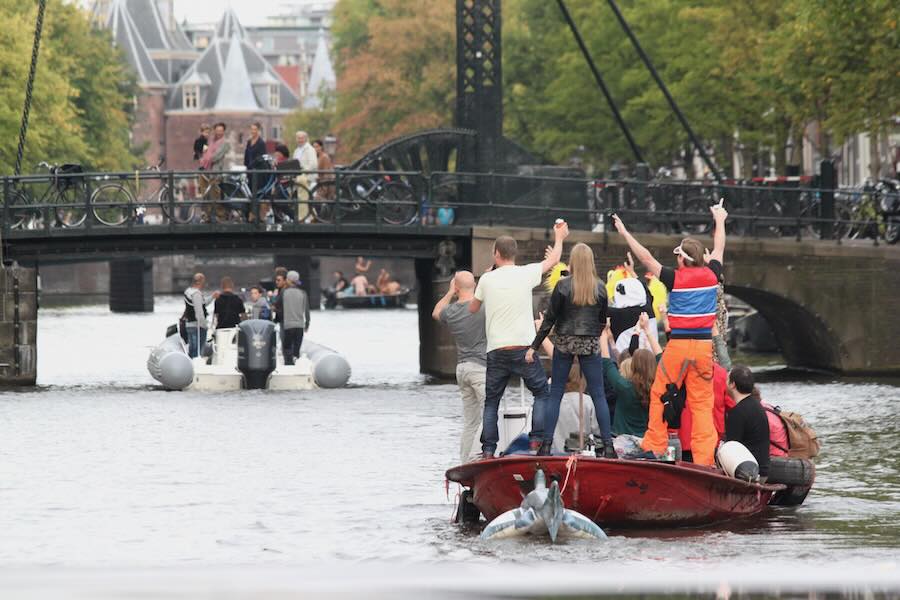 People boat cruising in Amsterdam channel